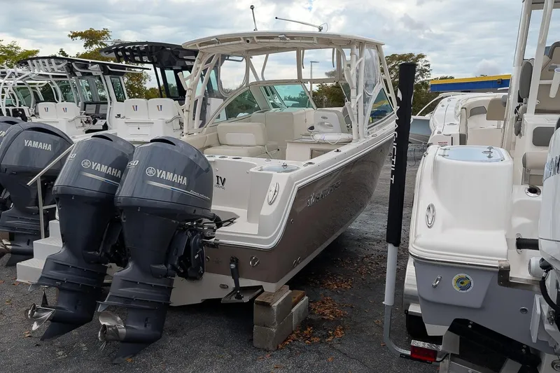Slide: The Image of 2014 Sailfish 275 DC boat with twin Yamaha engines in a marina. - 3