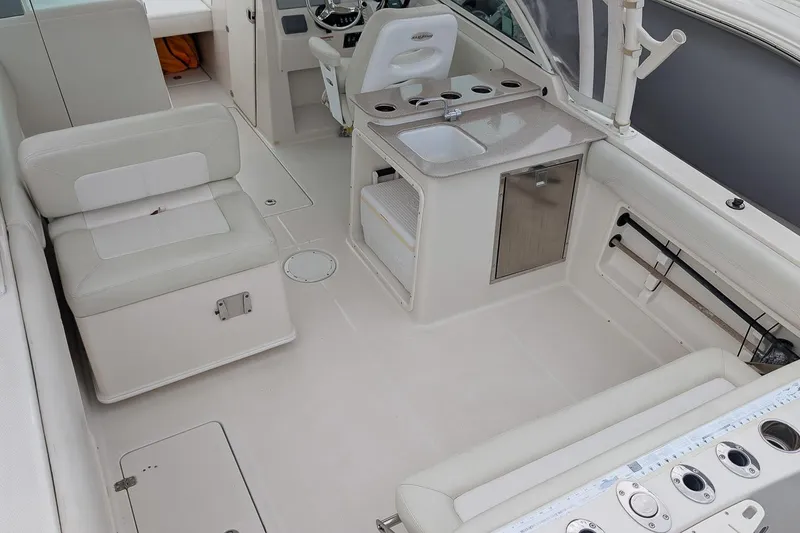 Slide: The Image of 2014 Sailfish 275 DC boat interior with seating, sink, and storage compartments. - 8