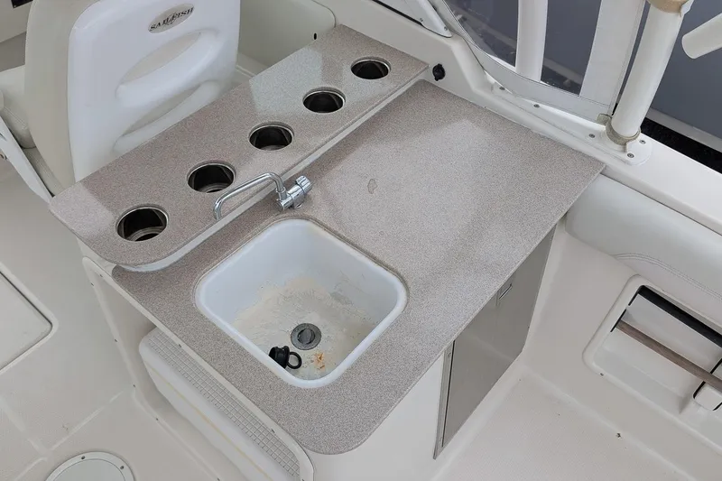 Slide: The Image of 2014 Sailfish 275 DC boat interior with sink and cup holders. - 9