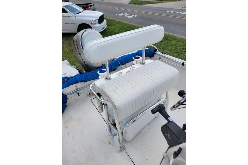 Slide: The Image of 2004 Sea Chaser 1950 RG boat interior with white seating and motor. - 10