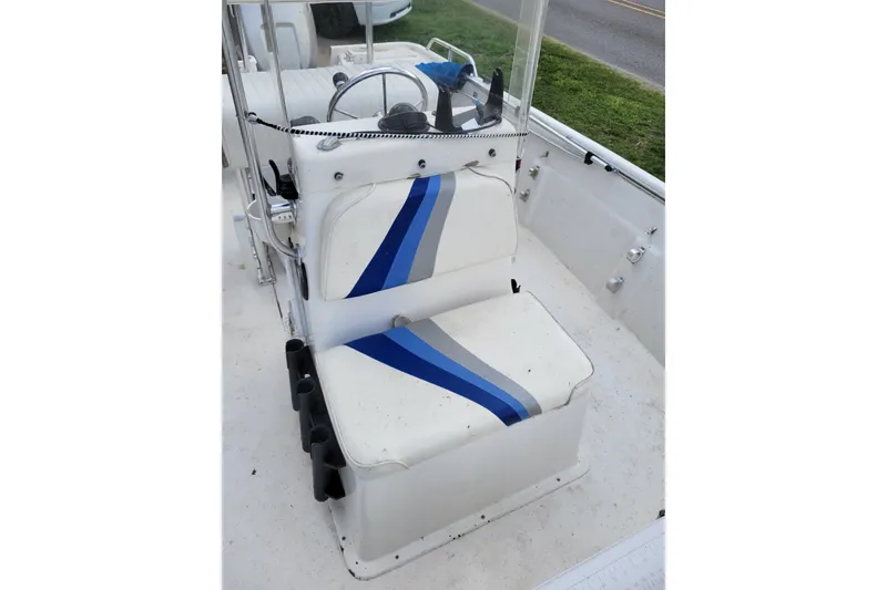 Slide: The Image of 2004 Sea Chaser 1950 RG boat interior with blue-striped seating and steering console. - 12