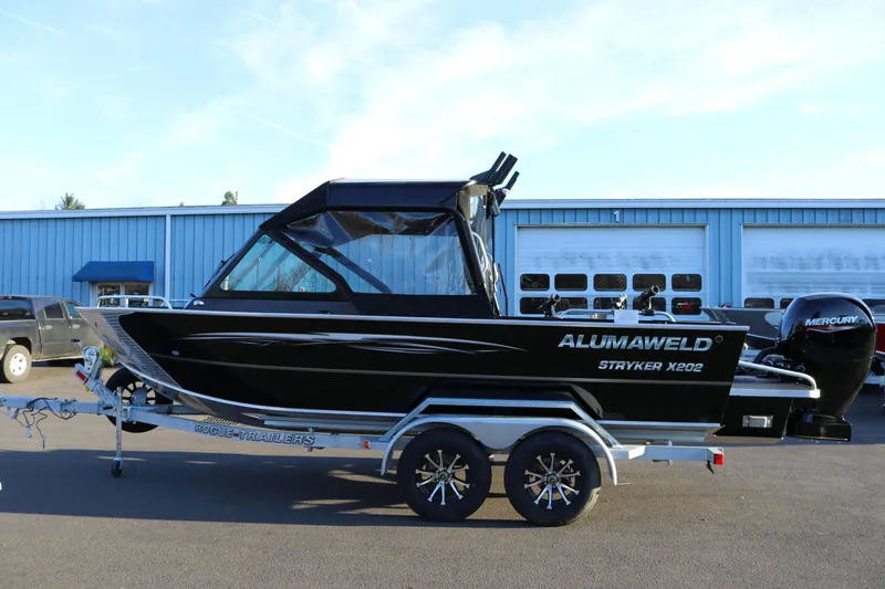 The Image of 2026 Alumaweld Stryker X202 boat on trailer, parked outside industrial building. - 0