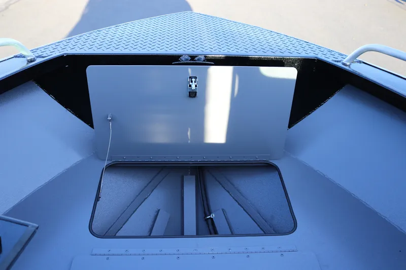 Slide: The Image of 2026 Alumaweld Stryker X202 boat storage compartment with open hatch and diamond plate flooring. - 13