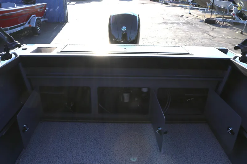 Slide: The Image of 2026 Alumaweld Stryker X202 boat interior with open storage compartments and visible engine. - 16