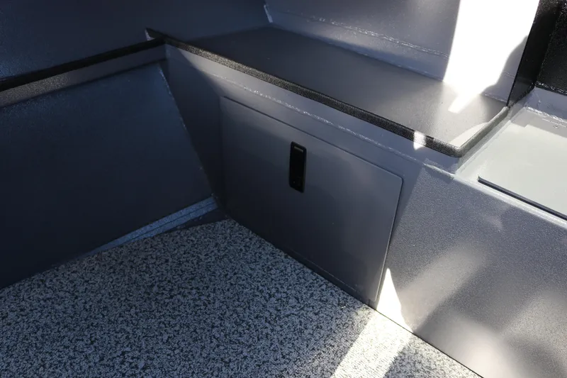 Slide: The Image of Interior view of 2026 Alumaweld Stryker X202 boat, featuring storage compartment and textured flooring. - 26