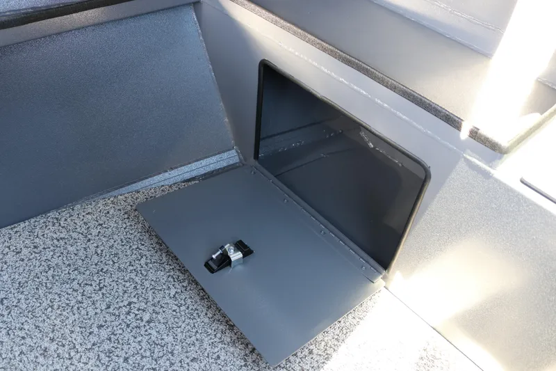 Slide: The Image of 2026 Alumaweld Stryker X202 storage compartment with open hatch and secure latch. - 27