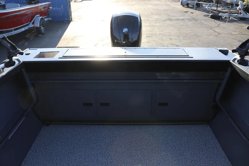 Slide: The Image of 2026 Alumaweld Stryker X202 boat interior with motor, docked in sunlight. - 30