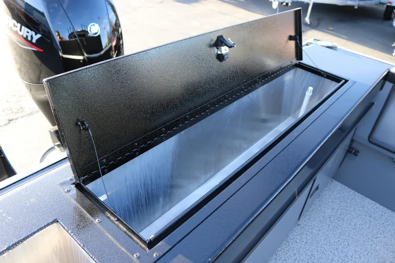 Slide: The Image of 2026 Alumaweld Stryker X202 boat with open storage compartment and Mercury engine. - 32