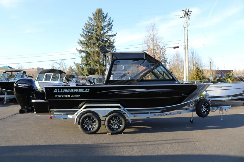 Slide: The Image of 2026 Alumaweld Stryker X202 boat on trailer, parked outdoors. - 4