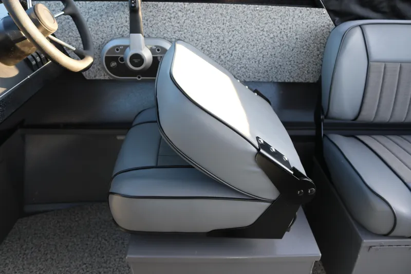 Slide: The Image of 2026 Alumaweld Stryker X202 boat interior with gray seating and steering wheel. - 7