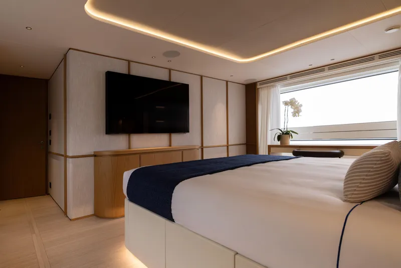 Slide: The Image of Luxurious bedroom interior of 2024 Benetti Oasis 34M yacht, featuring modern design and large window. - 31
