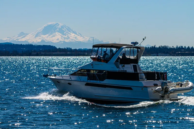 Slide: The Image of Ocean Alexander 42 yacht cruising on sparkling water with a mountain backdrop, 1989 model. - 18