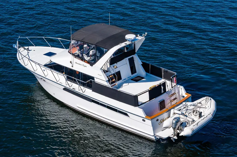 Slide: The Image of 1989 Ocean Alexander 42 yacht cruising on open water, featuring sleek design and spacious deck. - 19