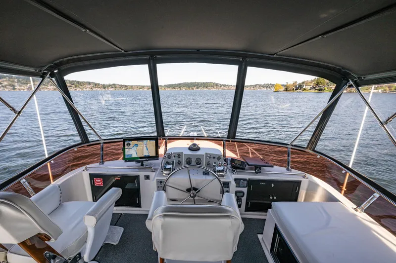 Slide: The Image of Cockpit view of 1989 Ocean Alexander 42 yacht on a serene lake. - 28