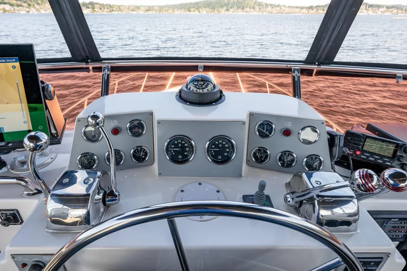 Slide: The Image of Cockpit view of 1989 Ocean Alexander 42 yacht with navigational instruments and steering wheel. - 33