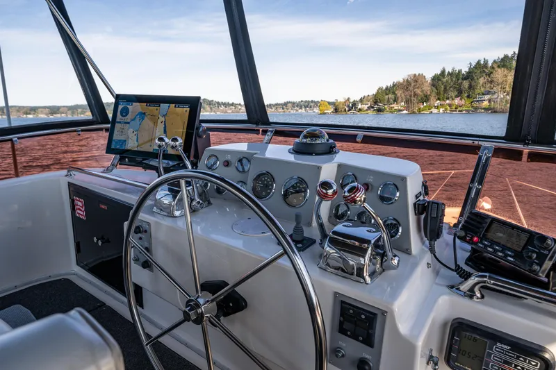Slide: The Image of Helm of 1989 Ocean Alexander 42 yacht with navigation equipment and scenic water view. - 34