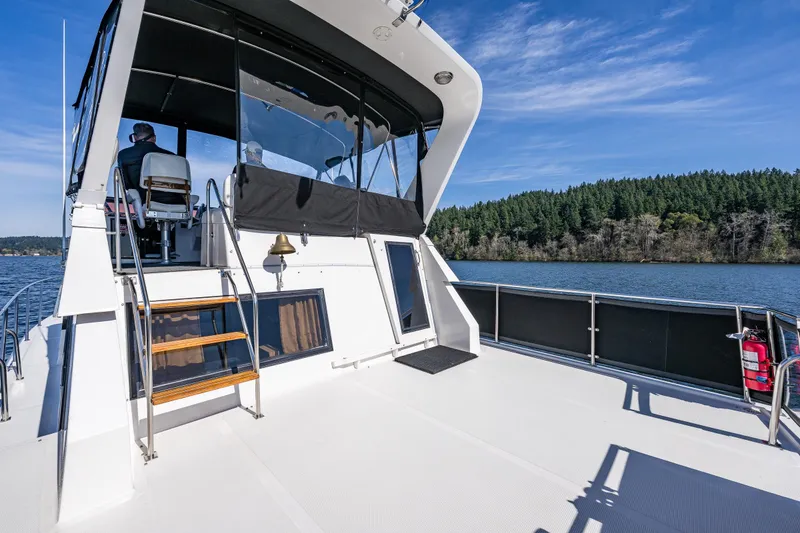 Slide: The Image of 1989 Ocean Alexander 42 yacht deck with scenic water and forest view. - 36