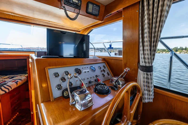 Slide: The Image of Interior helm of 1989 Ocean Alexander 42 yacht with wooden dashboard and modern controls. - 38