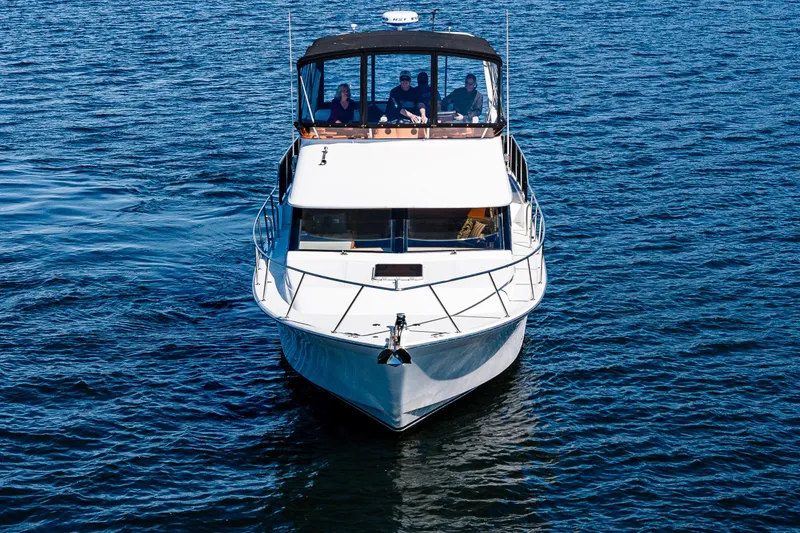 Slide: The Image of 1989 Ocean Alexander 42 yacht cruising on open water with passengers onboard. - 4