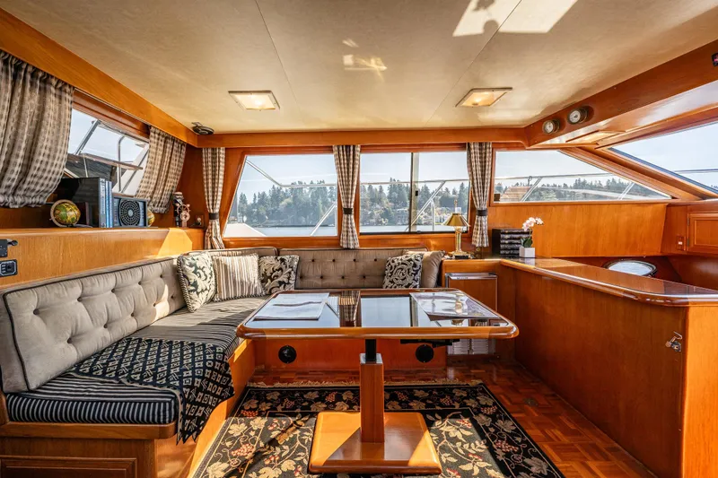 Slide: The Image of Luxurious interior of a 1989 Ocean Alexander 42 yacht with elegant wood finishes and plush seating. - 42