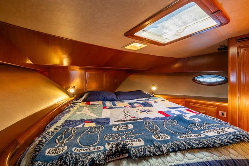 Slide: The Image of Cozy cabin interior of 1989 Ocean Alexander 42 yacht with nautical-themed bedding. - 50