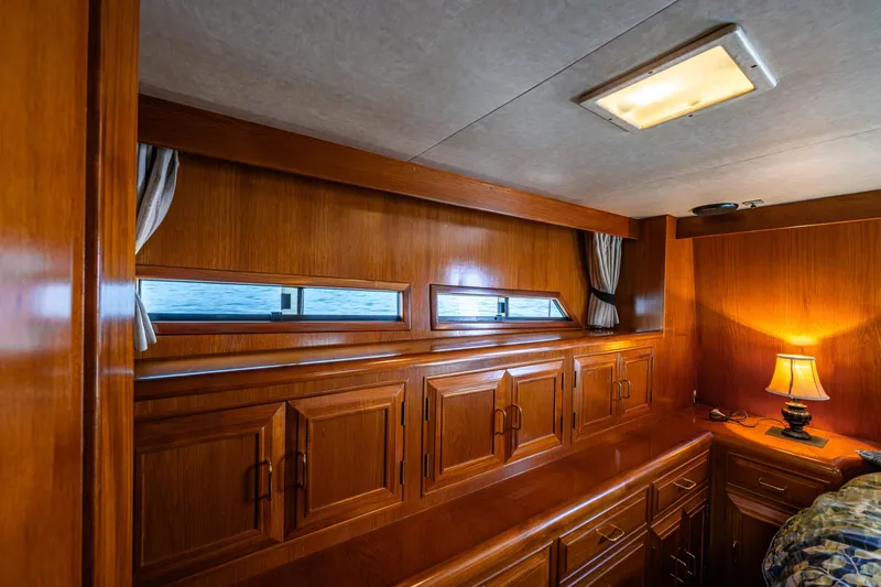 Slide: The Image of Luxurious wooden interior of 1989 Ocean Alexander 42 yacht cabin with ambient lighting. - 52