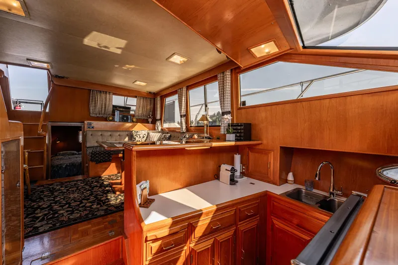 Slide: The Image of Luxurious 1989 Ocean Alexander 42 yacht interior with wood finishes and modern amenities. - 59