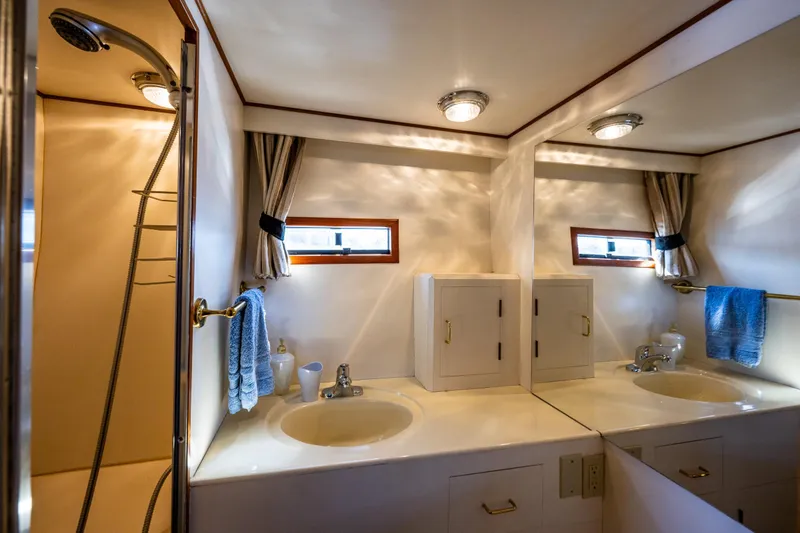 Slide: The Image of Luxurious bathroom interior of 1989 Ocean Alexander 42 yacht with dual sinks and shower. - 61