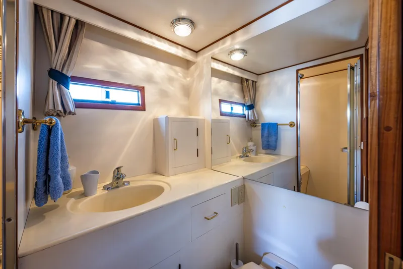 Slide: The Image of Bathroom interior of 1989 Ocean Alexander 42 yacht, featuring dual sinks and mirrors. - 63