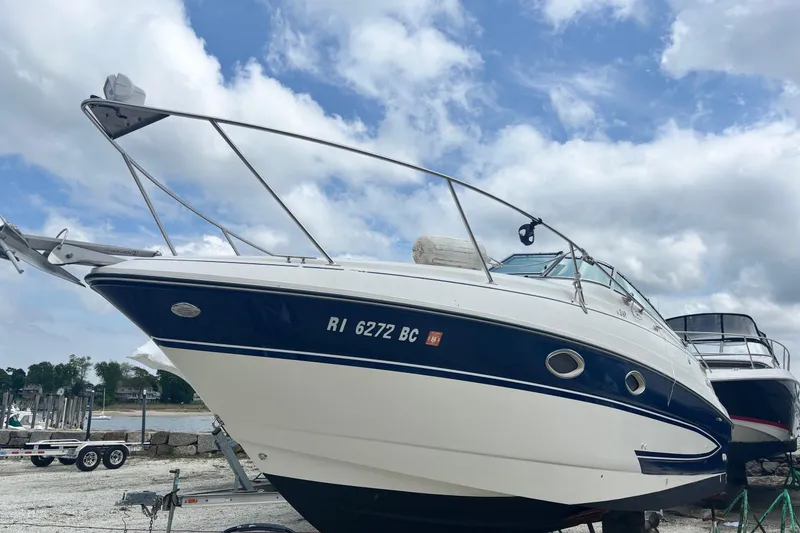 Slide: The Image of 2006 Glastron GS 269 boat on dry dock under a cloudy sky. - 10