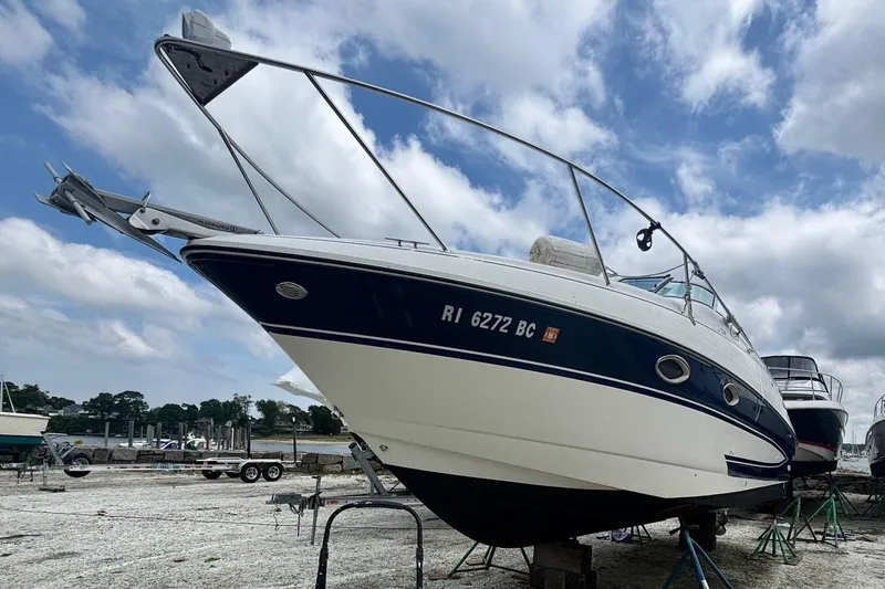 Slide: The Image of Interior of a 2006 Glastron GS 269 boat with white seating. - 13