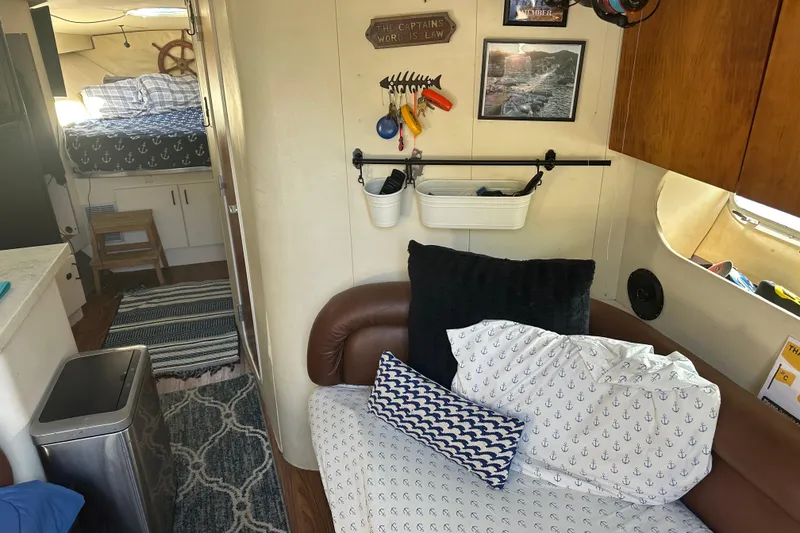 Slide: The Image of Interior of 1991 Mainship Mediterranean 36 Express with nautical decor and cozy seating. - 10