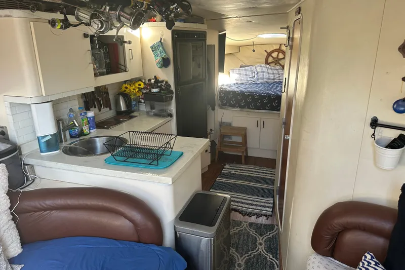 Slide: The Image of 1991 Mainship Mediterranean 36 Express interior with kitchen, bed, and cozy seating area. - 12