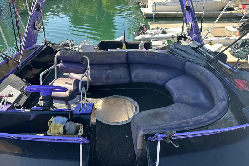 Slide: The Image of 1991 Mainship Mediterranean 36 Express boat interior with curved seating and steering wheel. - 3