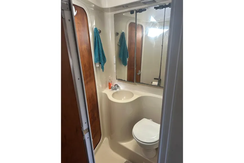 Slide: The Image of Bathroom interior of 1991 Mainship Mediterranean 36 Express yacht, featuring sink and toilet. - 5