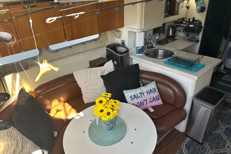 Slide: The Image of Cozy interior of 1991 Mainship Mediterranean 36 Express with kitchen and seating area. - 7