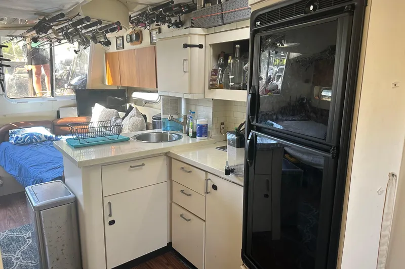 Slide: The Image of Interior of 1991 Mainship Mediterranean 36 Express with kitchen and living area. - 8