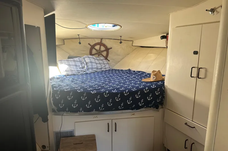 Slide: The Image of Cozy cabin interior of 1991 Mainship Mediterranean 36 Express with nautical bedding and decor. - 9