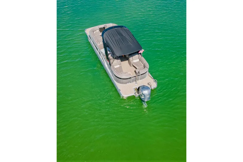 Slide: The Image of Aerial view of a 2018 Bennington 25 QSR pontoon boat on vibrant green water. - 13