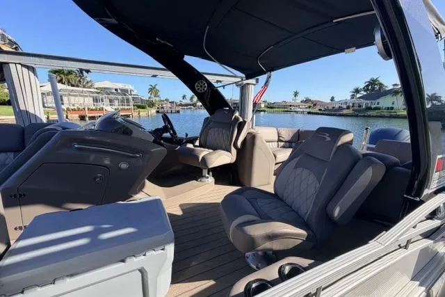 Slide: The Image of 2018 Bennington 25 QSR pontoon boat interior with luxurious seating and waterfront view. - 22