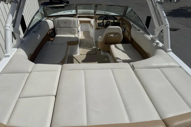 Slide: The Image of Interior of a 2016 Cobalt 220 boat with beige and white seating. - 11