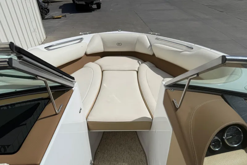 Slide: The Image of 2016 Cobalt 220 boat interior with beige seating and sleek design. - 15