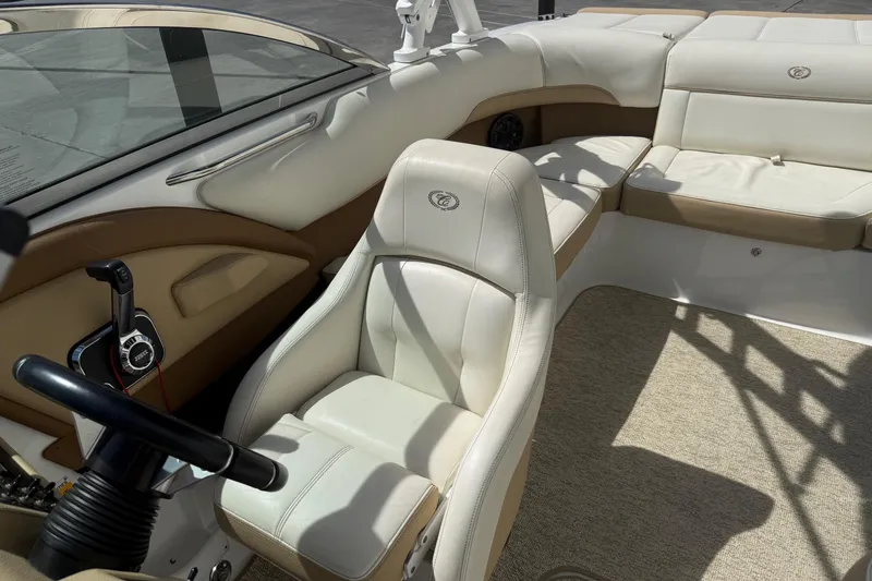 Slide: The Image of Interior of a 2016 Cobalt 220 boat with beige and white seating. - 16