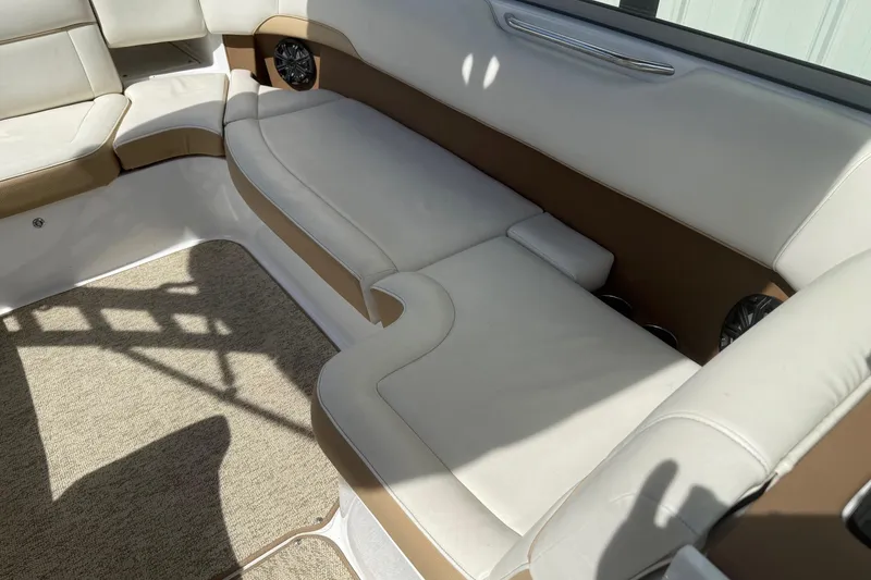 Slide: The Image of Interior of a 2016 Cobalt 220 boat with beige and white seating. - 17