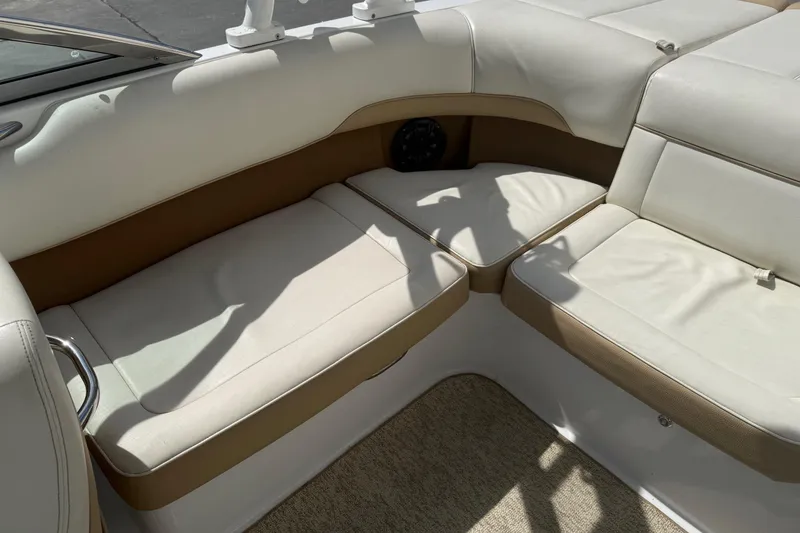 Slide: The Image of Interior seating of a 2016 Cobalt 220 boat with beige upholstery. - 18