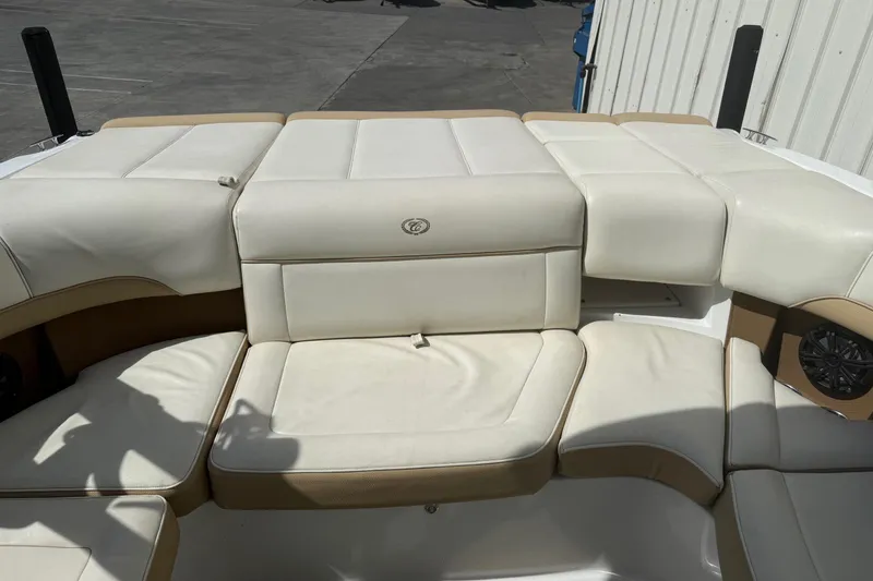 Slide: The Image of 2016 Cobalt 220 boat interior with white and tan cushioned seating. - 19