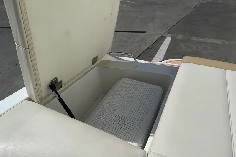 Slide: The Image of Open storage compartment on a 2016 Cobalt 220 boat with an Igloo cooler inside. - 21