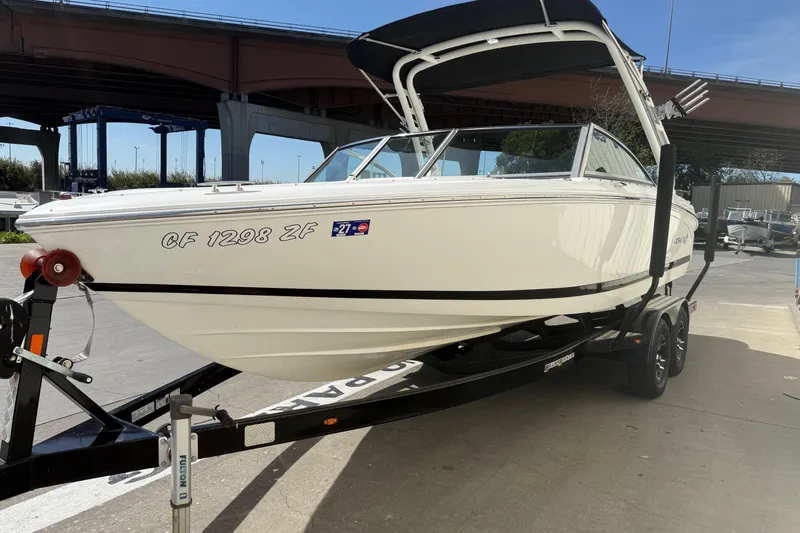 Slide: The Image of 2016 Cobalt 220 boat on trailer under bridge, side view. - 3