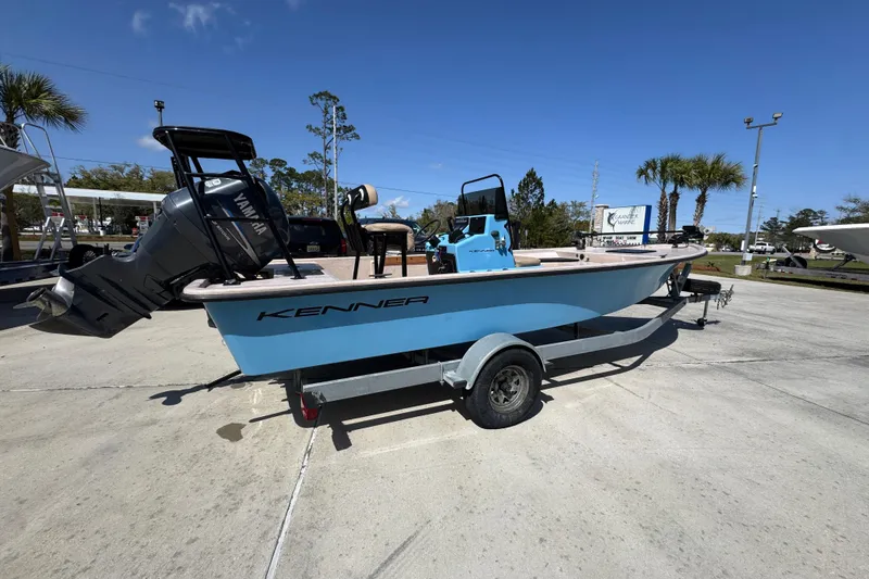 Slide: The Image of 2004 Kenner 21 VX boat with Yamaha motor on trailer, parked outdoors. - 10