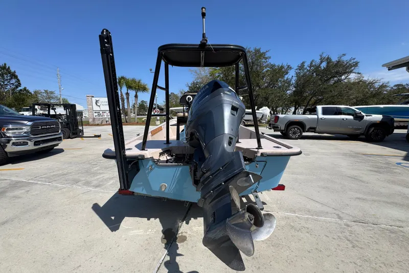 Slide: The Image of 2004 Kenner 21 VX boat with outboard motor in a parking lot. - 12